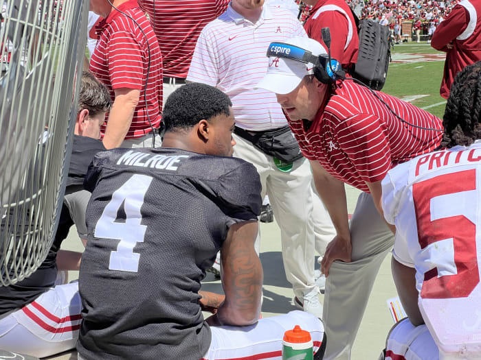 Tommy Rees talks on the sideline with Jalen Milroe